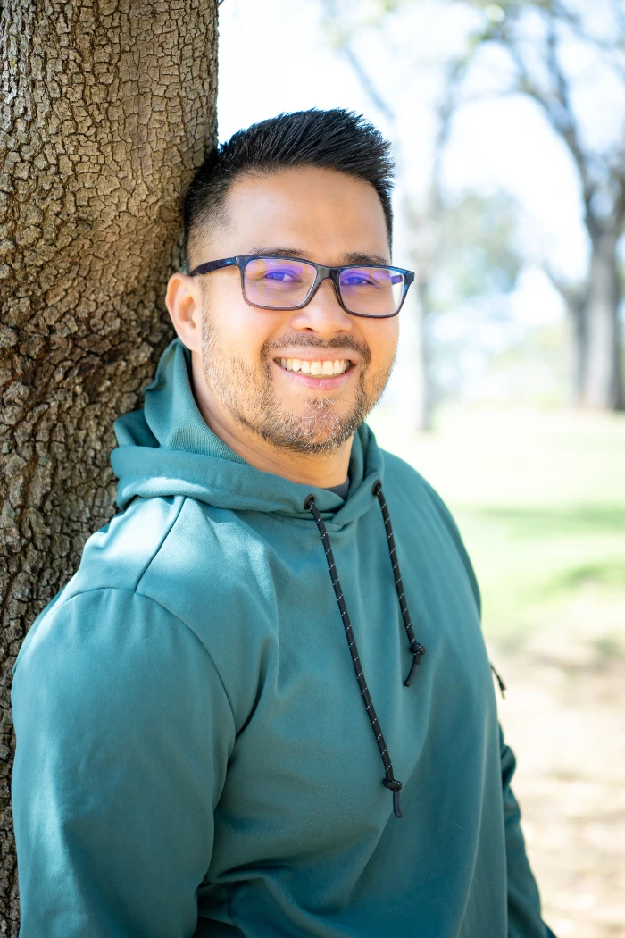 midshot of mark sison wearing a green hoodie and pants, mindfulness guide in southlake, tx