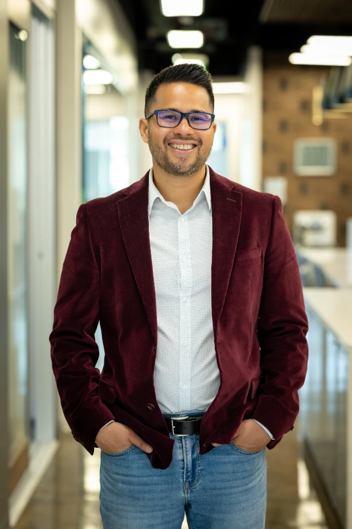 professional midshot of mark sison in a burgundy jacket, blue jeans, and a white collared shirt. Health Coach | Family Specialist | Mindfulness Guide in southlake tx